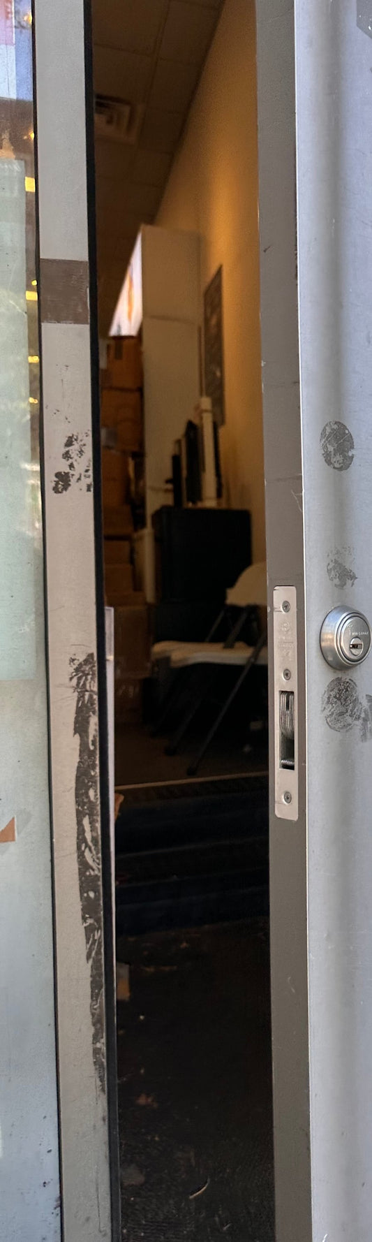 Storefront door edge with a mortise cylinder and a deadbolt that only throws halfway